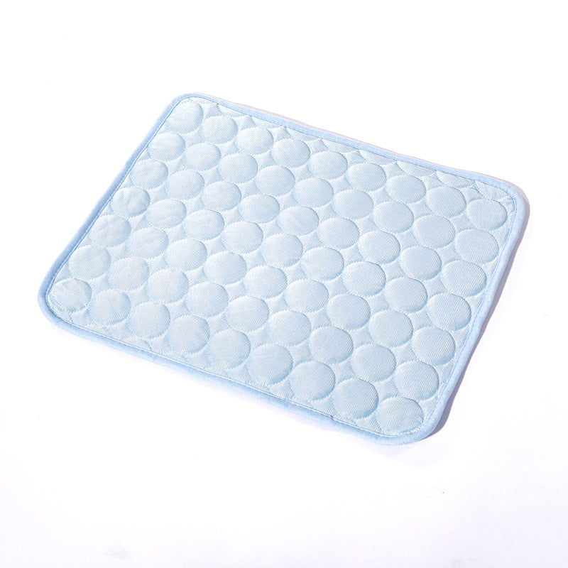 Dog cooling mat in light blue color, featuring a textured circular design for pet comfort during hot weather.